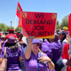 Workers of South African Airways (SAA) hold placards during a strike over wages and job cuts at SAA headquarters in Kempton Park, South Africa, Nov. 15, 2019.